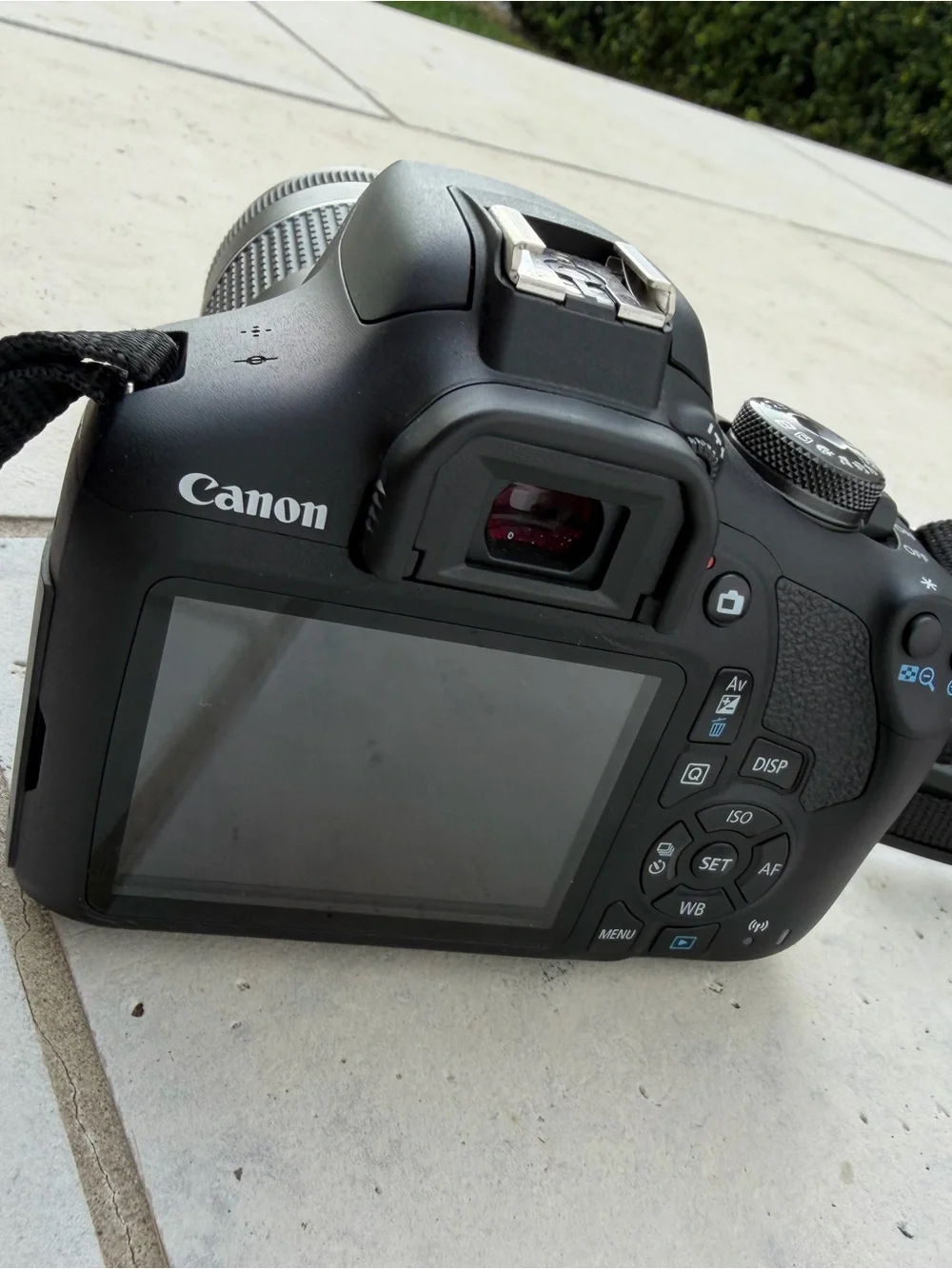 Canon DSLR Camera in Black with Red-Trim Strap and Black Zoom Lens